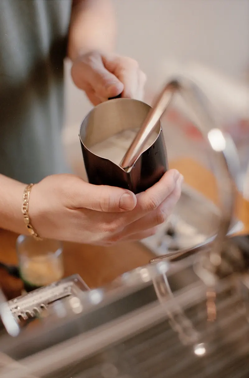 Milk steaming, mid-pour, shot on film